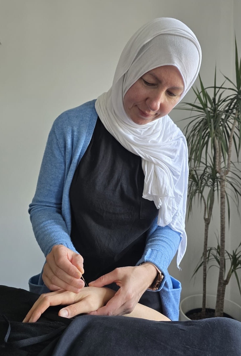 Female practitioner giving acupuncture treatment to a female patient at Vireya Wellness, Marylebone